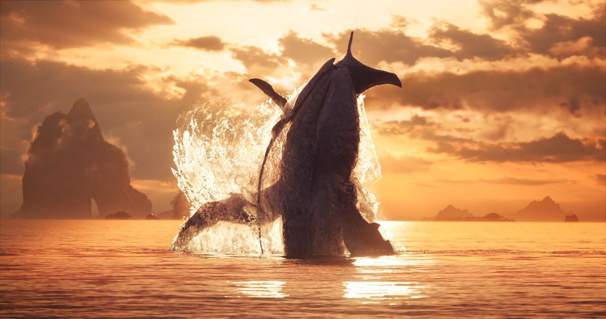 A giant sea creature shoots out of the water under a golden sky "Avatar: The Way of Water."