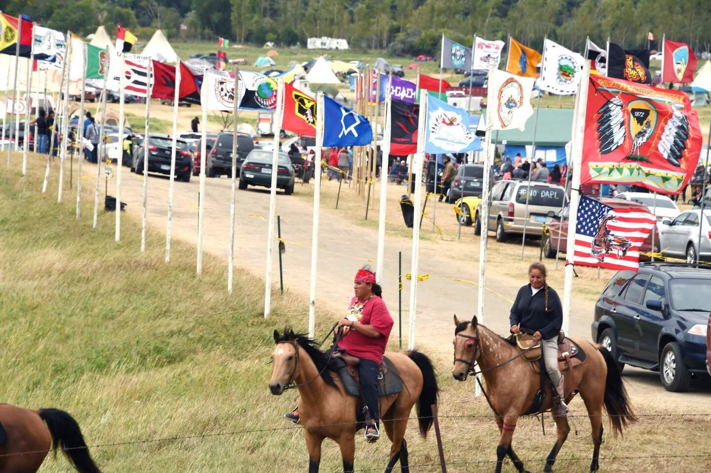 Flags of Native American tribes from across the U.S. and Canada line the entrance to a protest encampment near Cannon Ball, N.D., where members of the Standing Rock Sioux tribe and their supporters have gathered to voice their opposition to the Dakota Access Pipeline.