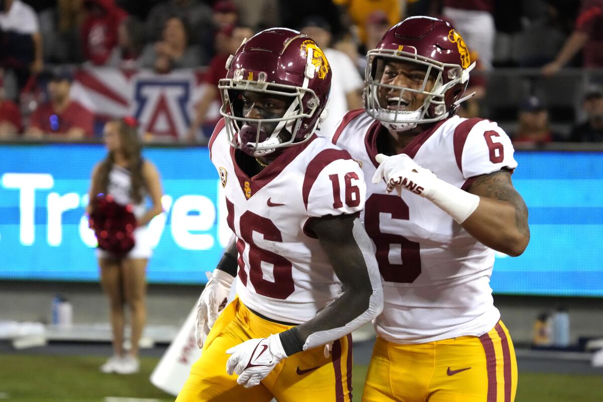 Southern California wide receiver Tahj Washington (16) celebrates with running back Austin Jones.