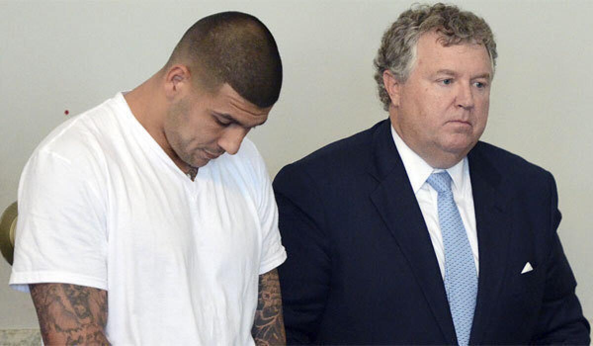 Former New England Patriots tight end Aaron Hernandez, left, stands with his attorney Michael Fee during arraignment in Attleborough District Court last week.