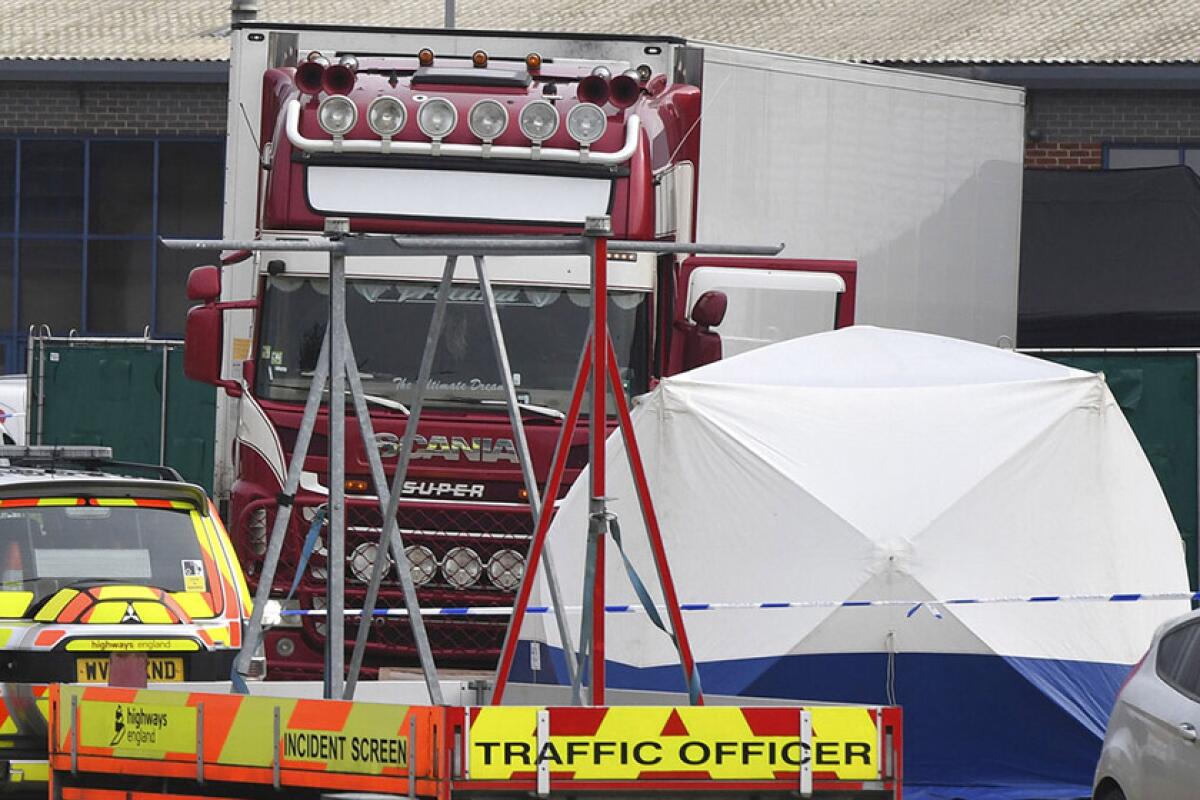 Police barriers were placed near a truck that was found to contain 39 bodies.