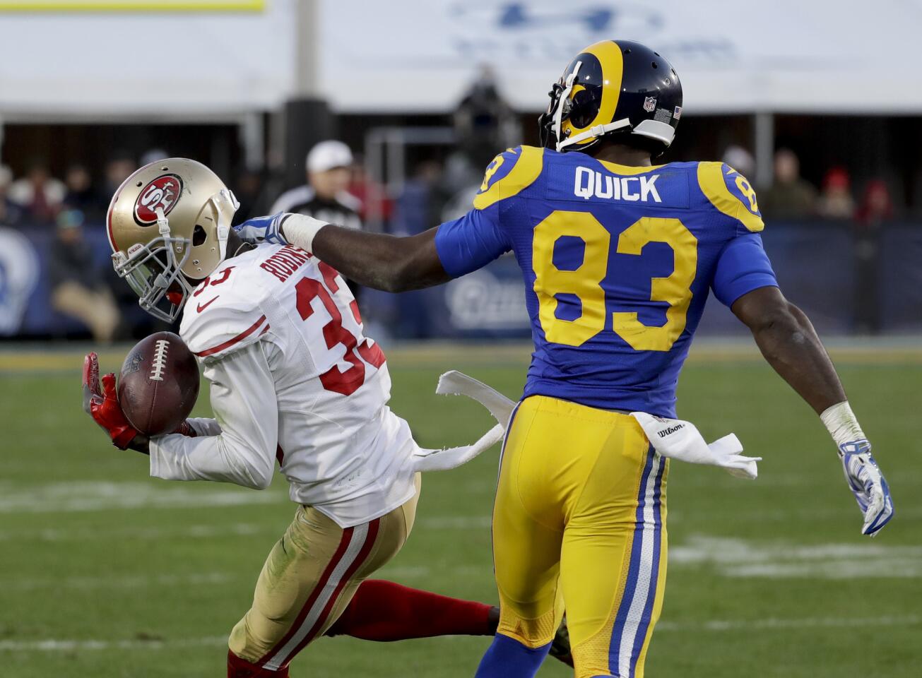 San Francisco 49ers cornerback Rashard Robinson, left, intercepts a pass intended for Los Angeles Rams wide receiver Brian Quick during the second half of an NFL football game Saturday, Dec. 24, 2016, in Los Angeles. (AP Photo/Rick Scuteri)