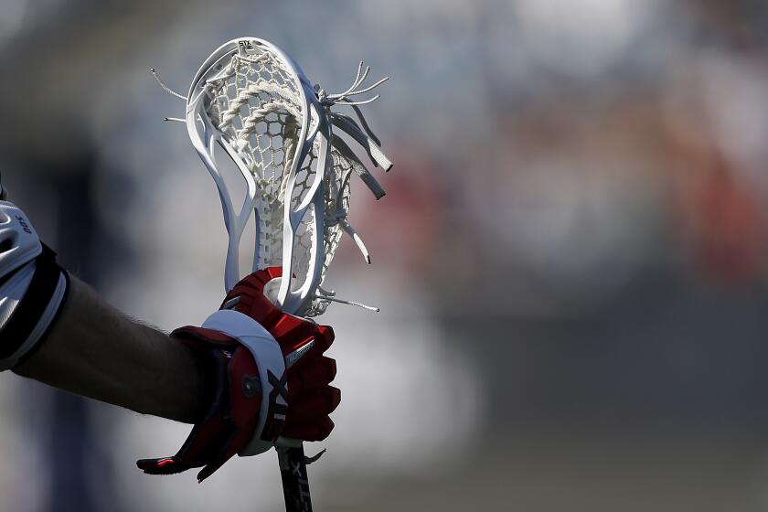 A closeup, detail view of a lacrosse stick being held during a Premier Lacrosse League.