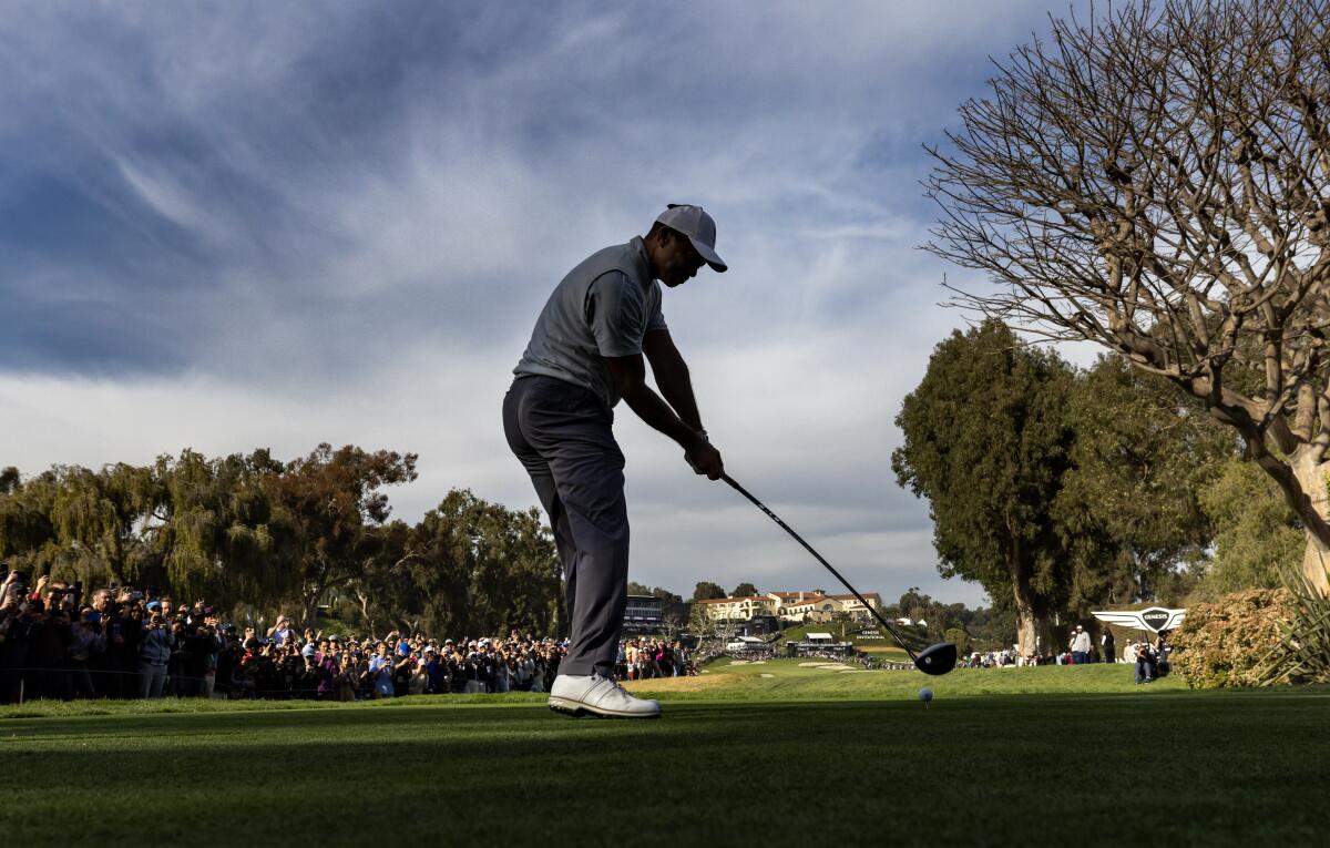 Tiger Woods tees off on the ninth hole in the third round.