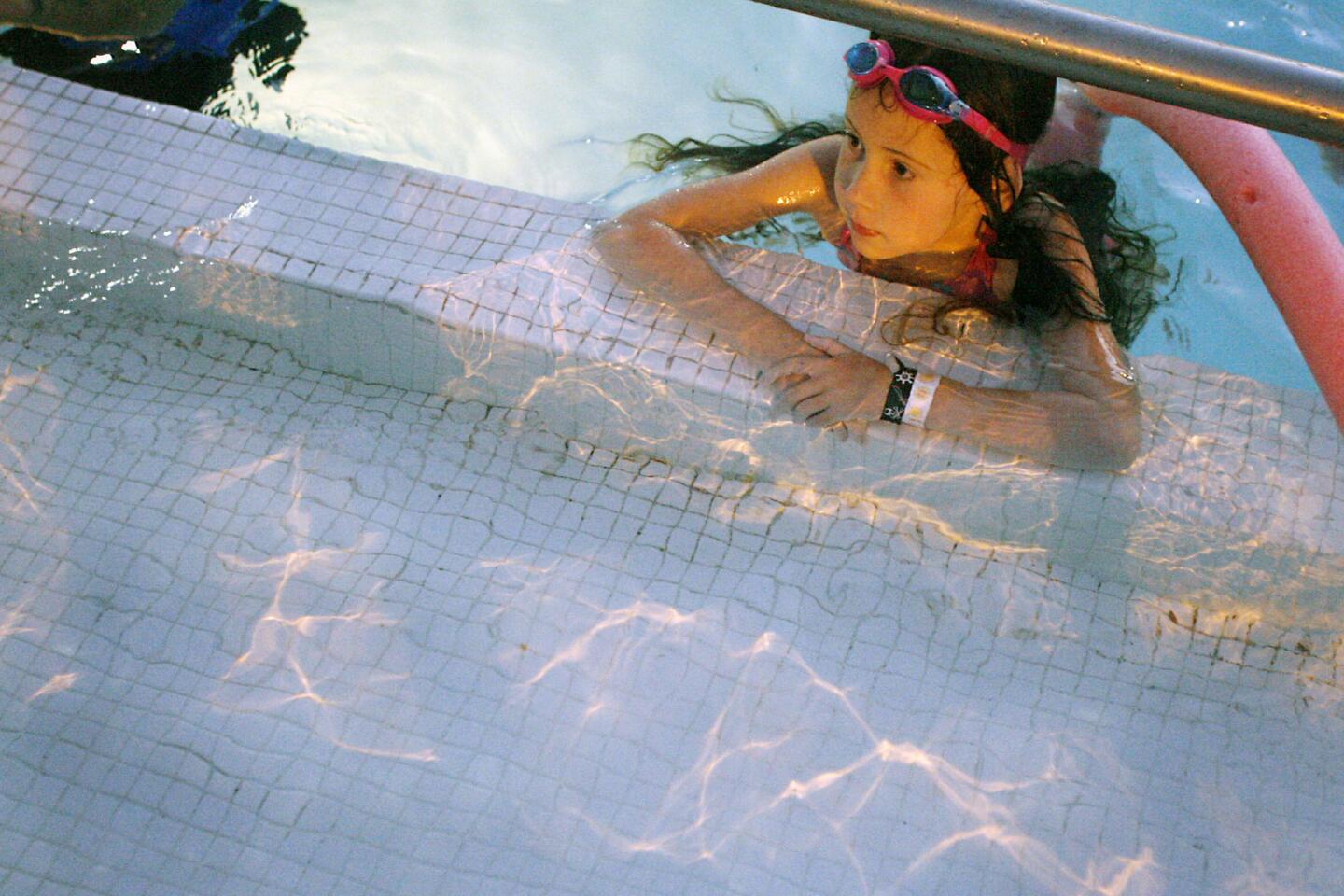 Mckenna Dahlen, 7, watches Dolphin Tales during Dive-In Movie Night, which took place at the Rose Bowl Aquatics Center in Pasadena on Saturday, June 23, 2012.