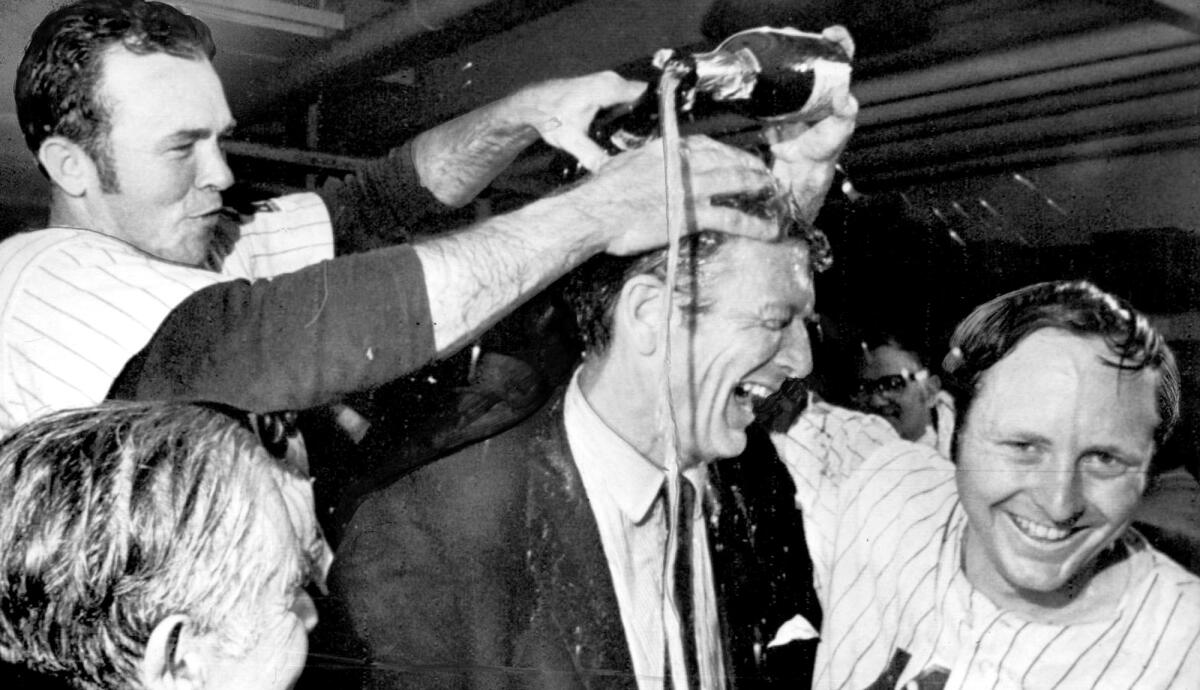 The Mets' Rod Gaspar, right, and Jerry Grote give New York Mayor John Lindsay a champagne shower after clinching the NL pennant in 1969.