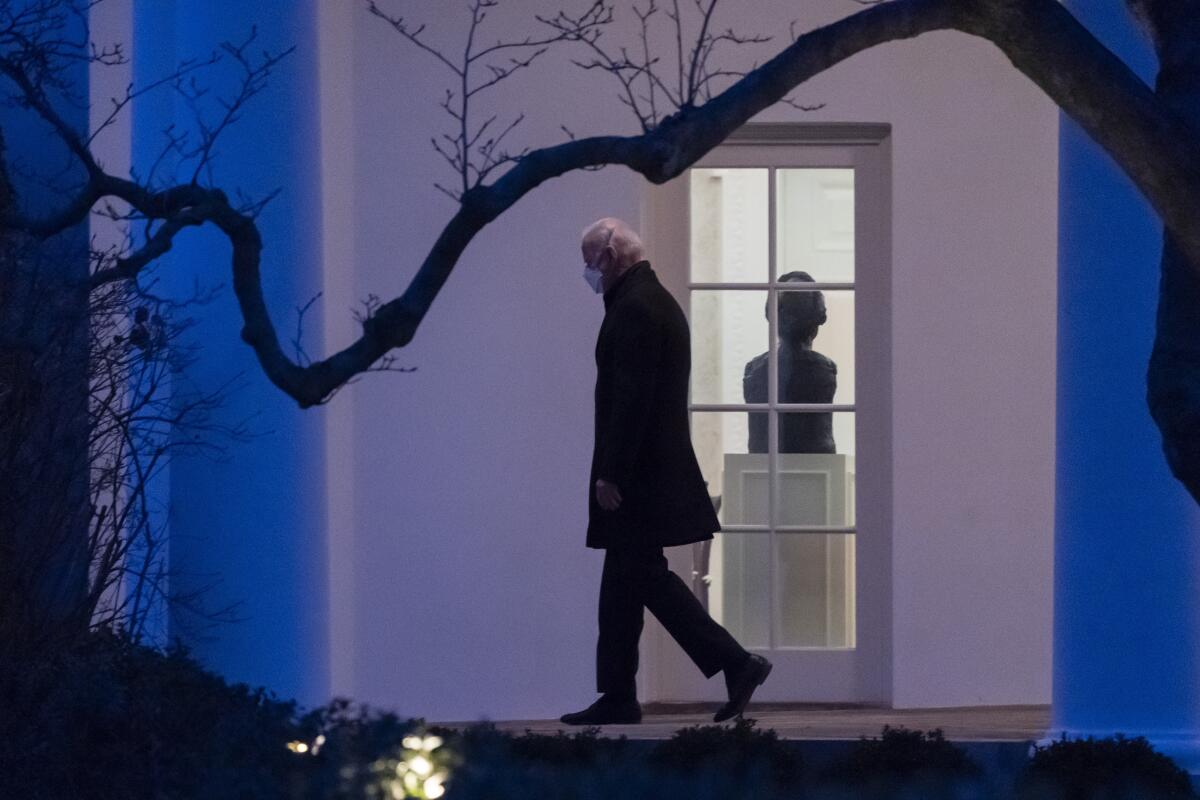 President Joe Biden walks at the White House, Friday, Feb. 12, 2021