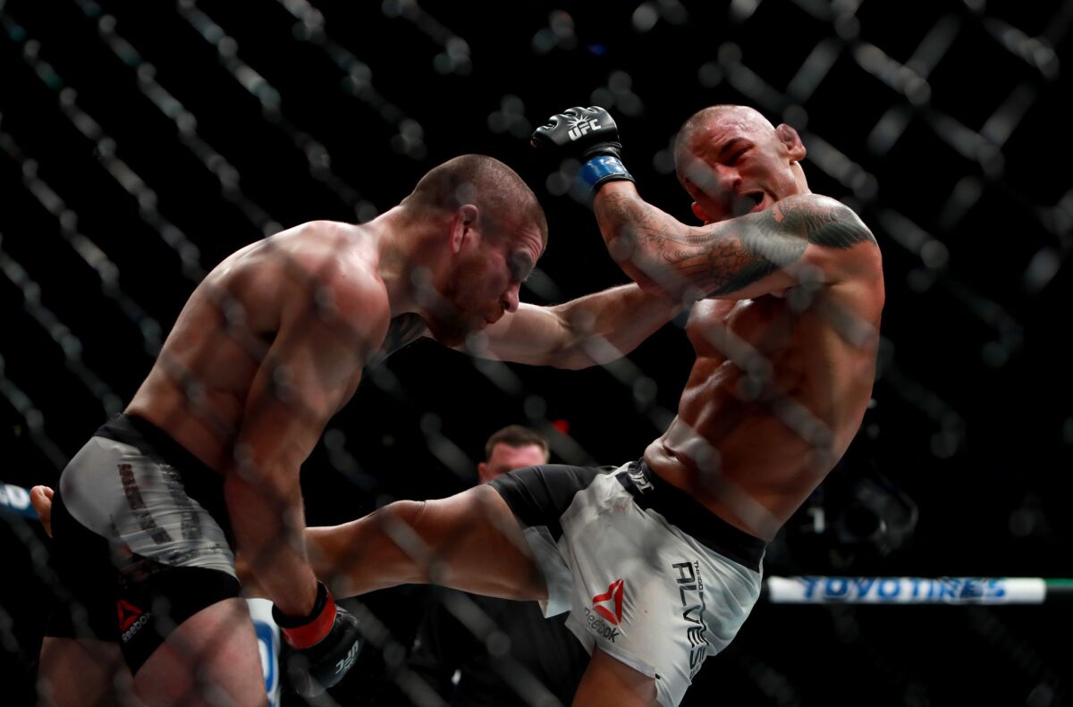 Jim Miller, left and Thiago Alves trade blows during their catchweight bout at UFC 205.