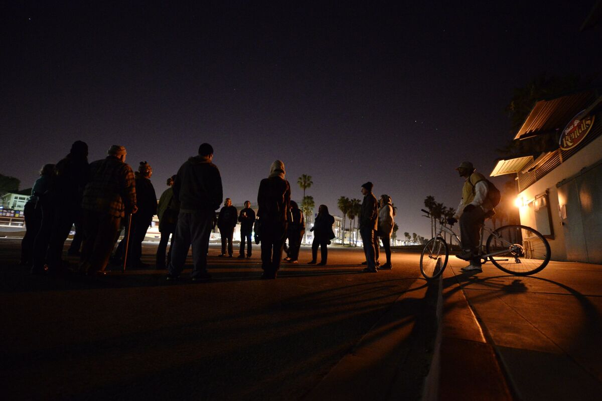 Protesters gather to challenge the midnight-to-5 a.m. beach curfew in Venice, which they claim is selectively enforced to harass homeless people.