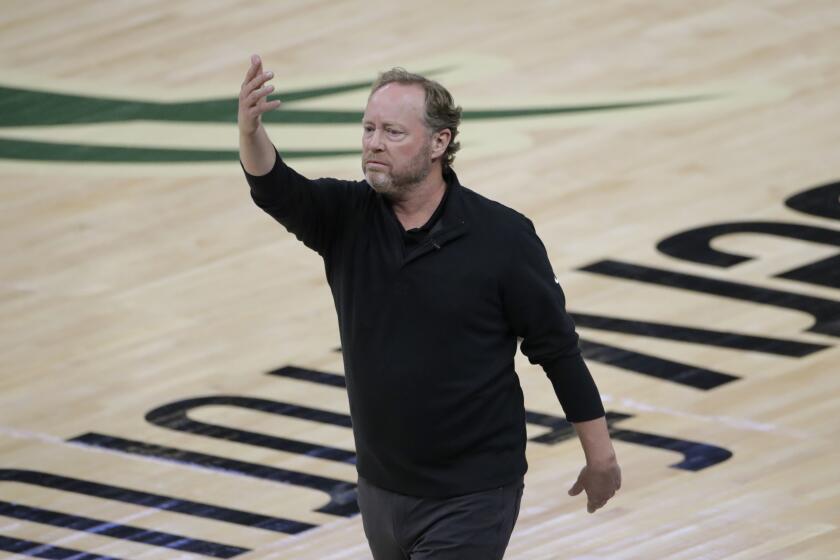 Milwaukee Bucks coach Mike Budenholzer directs the team during a 2021 playoff game against the Suns.