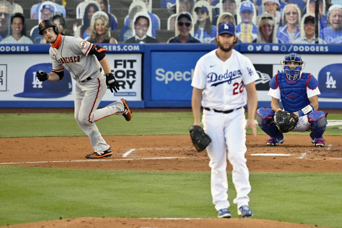 The Giants' Austin Slater, left, runs after hitting a solo homer off Dodgers starting pitcher Clayton Kershaw, front.