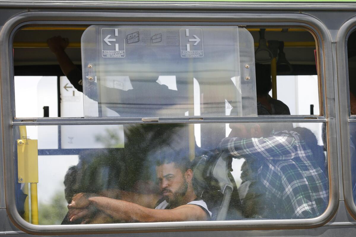 Supporters of former Brazilian President Jair Bolsonaro are taken by bus to a federal prison