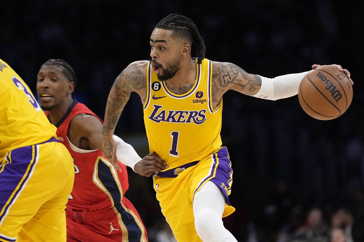 Los Angeles Lakers guard D'Angelo Russell, right, drives past New Orleans.