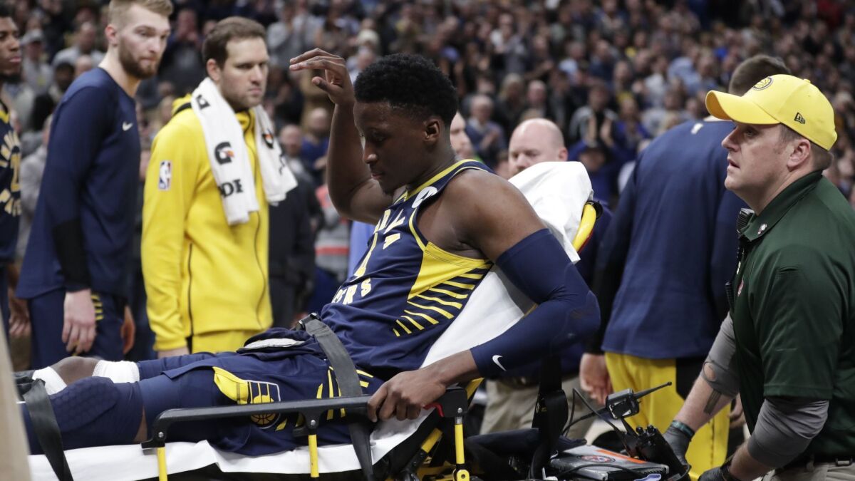 Pacers guard Victor Oladipo is taken off the court on a stretcher after he was injured during the first half of a game against the Raptors on Wednesday.