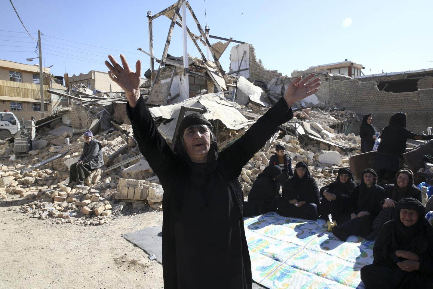 A woman mourns at an earthquake site in Sarpol-e-Zahab in western Iran on Nov. 14, 2017. Rescuers are digging through the debris of buildings felled by the Sunday earthquake in the border region of Iran and Iraq.