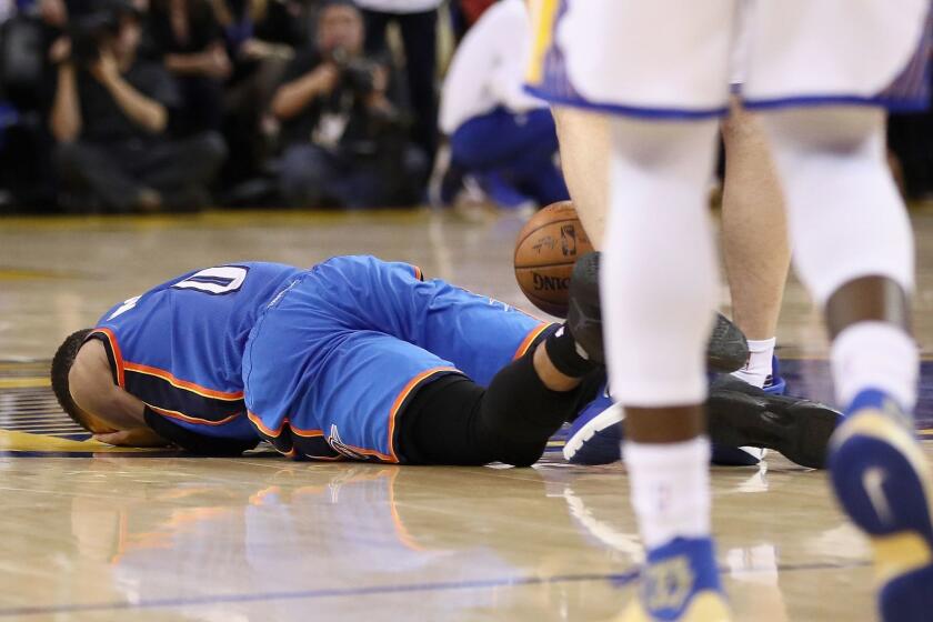 Oklahoma City's Russell Westbrook lies on the court after being fouled by Golden State's Zaza Pachulia on Jan. 18.