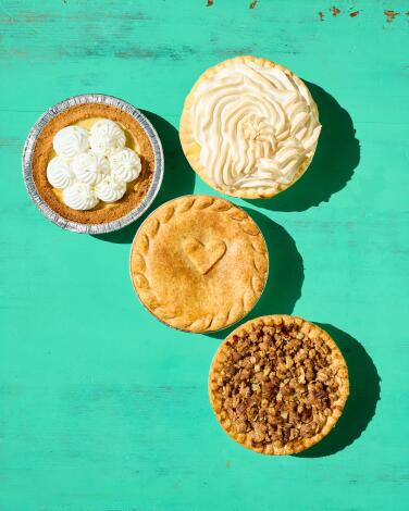 A selection of sweet and savory pies from Crustees, a family-owned bakery in View Park-Windsor Hills, including key lime pie, peach and apple cobbler and a curry chicken pot pie. (Rebecca Peloquin / For The Times)