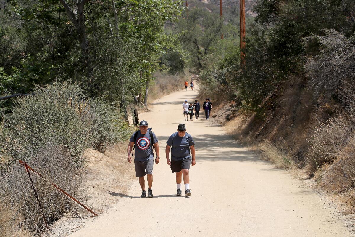 Hikers stroll along a trail at Black Star Canyon in Silverado.