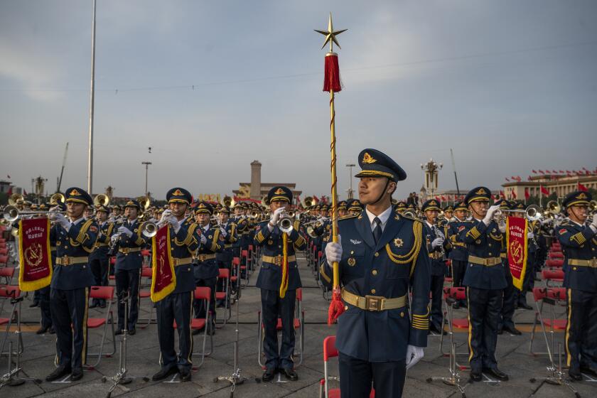 BEIJING, CHINA - JULY 01: A Chinese military band conductor stands in front of band members at a ceremony marking the 100th anniversary of the Communist Party on July 1, 2021 at Tiananmen Square in Beijing, China. (Photo by Kevin Frayer/Getty Images)
