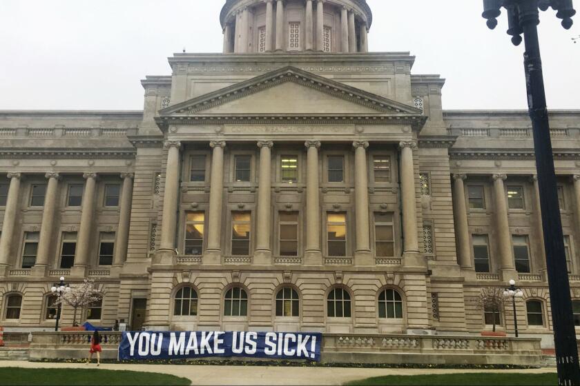 A sign hangs from the Kentucky Capitol on Monday, April 2, 2018, in Frankfort, Ky. Teachers and other public workers are expected to protest recent changes to the pension system and a two-year spending plan lawmakers could approve Monday. (AP Photo/Adam Beam)