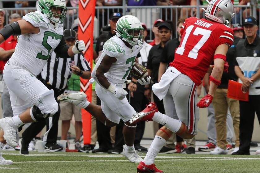 Oregon running back CJ Verdell, center, scores a touchdown against Ohio State during the first half of an NCAA college football game Saturday, Sept. 11, 2021, in Columbus, Ohio. (AP Photo/Jay LaPrete)