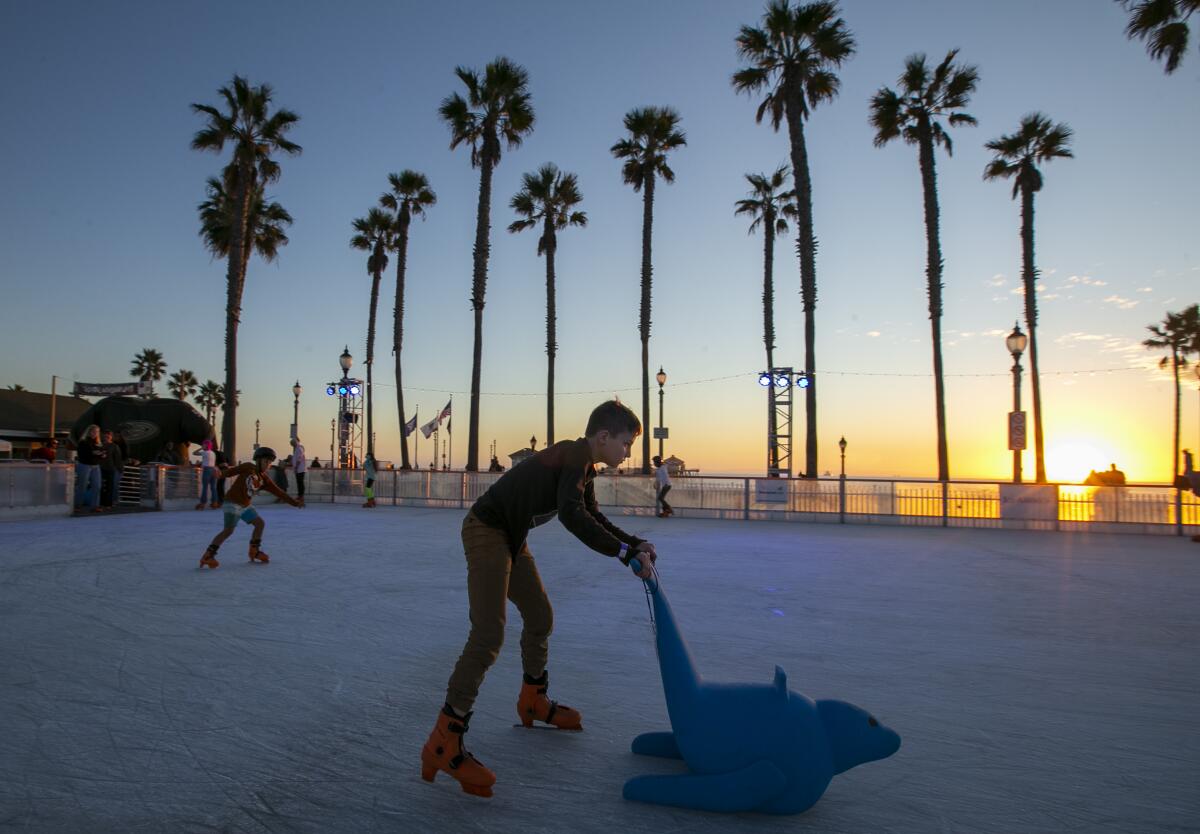 A guest skates at the Surf City Winter Wonderland at the Huntington Beach Pier Plaza on Friday.