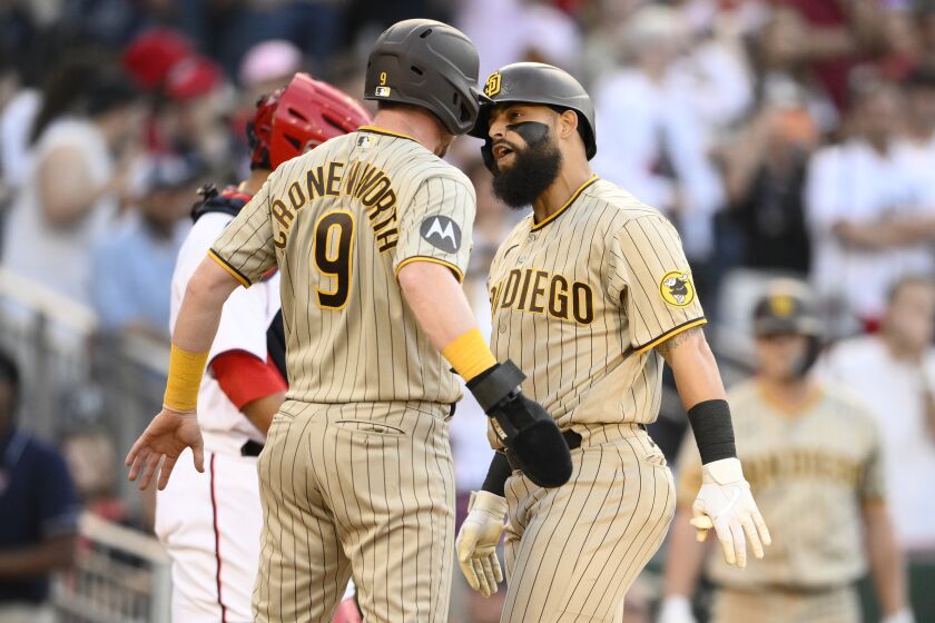 San Diego Padres' Rougned Odor, right, celebrates his three-run home run against the Washington Nationals with Jake Cronenworth (9) during the ninth inning of a baseball game Thursday, May 25, 2023, in Washington. The Padres won 8-6. (AP Photo/Nick Wass)