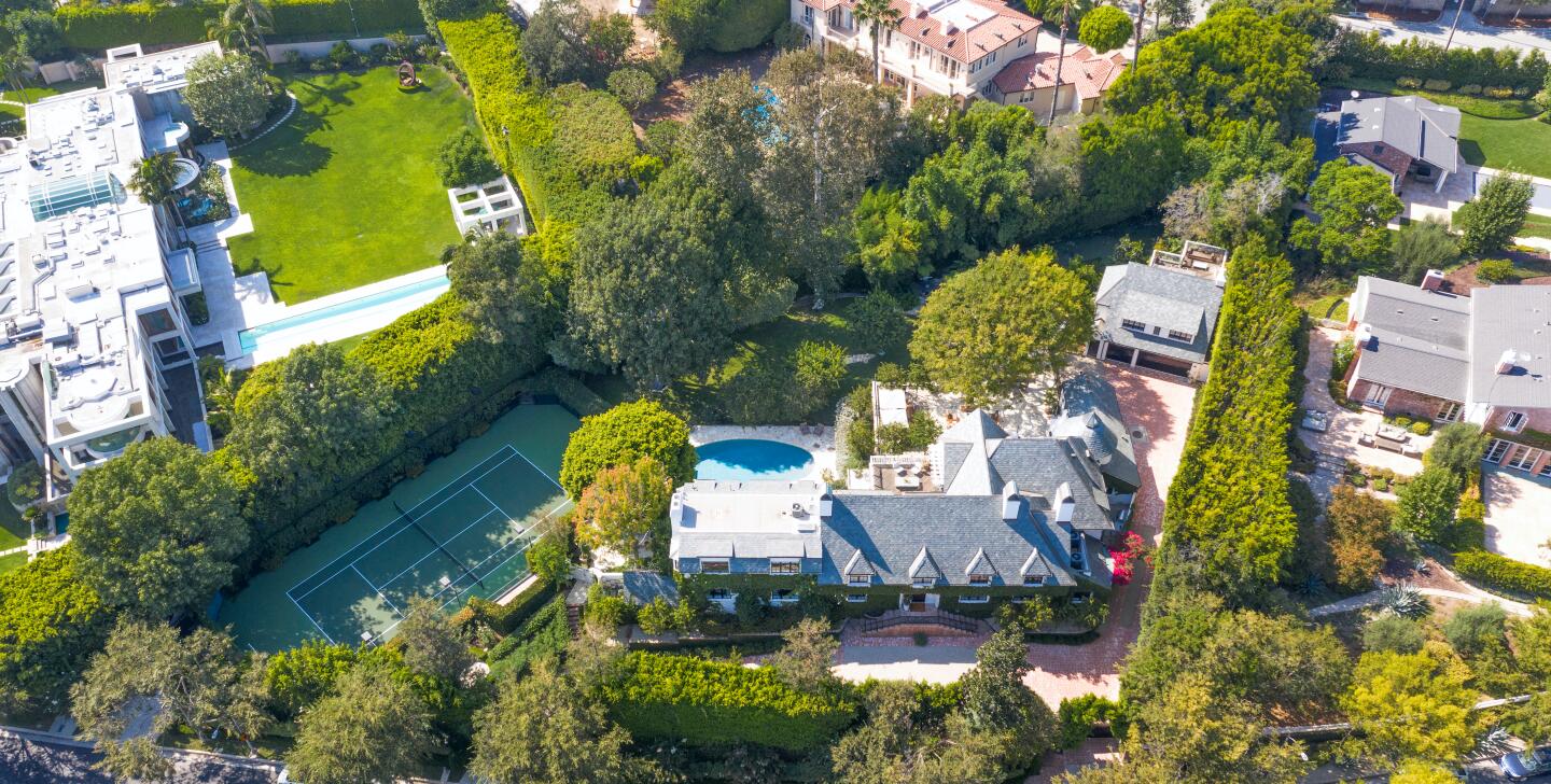 The ivy-draped traditional spans 10,400 square feet with five bedrooms and nine bathrooms.