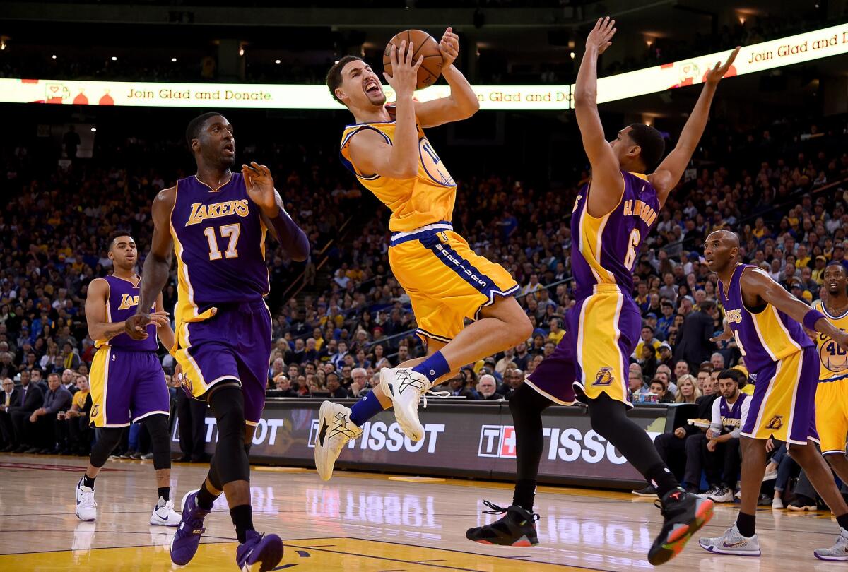 Golden State guard Klay Thompson is fouled as he shoots over Lakers guard Jordan Clarkson during a game on Nov. 24.