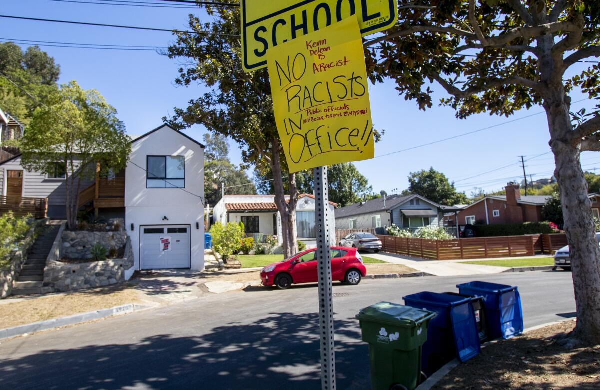 A protest sign saying 'No racists in office' near Kevin de León's home in Eagle Rock