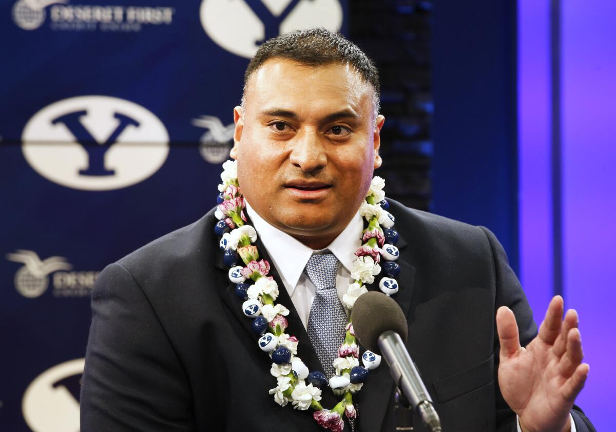 Brigham Young Coach Kalani Sitake talks to the press during an introductory news conference.