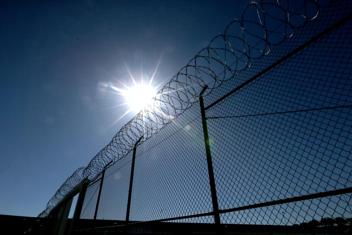 A fence topped with razor wire.