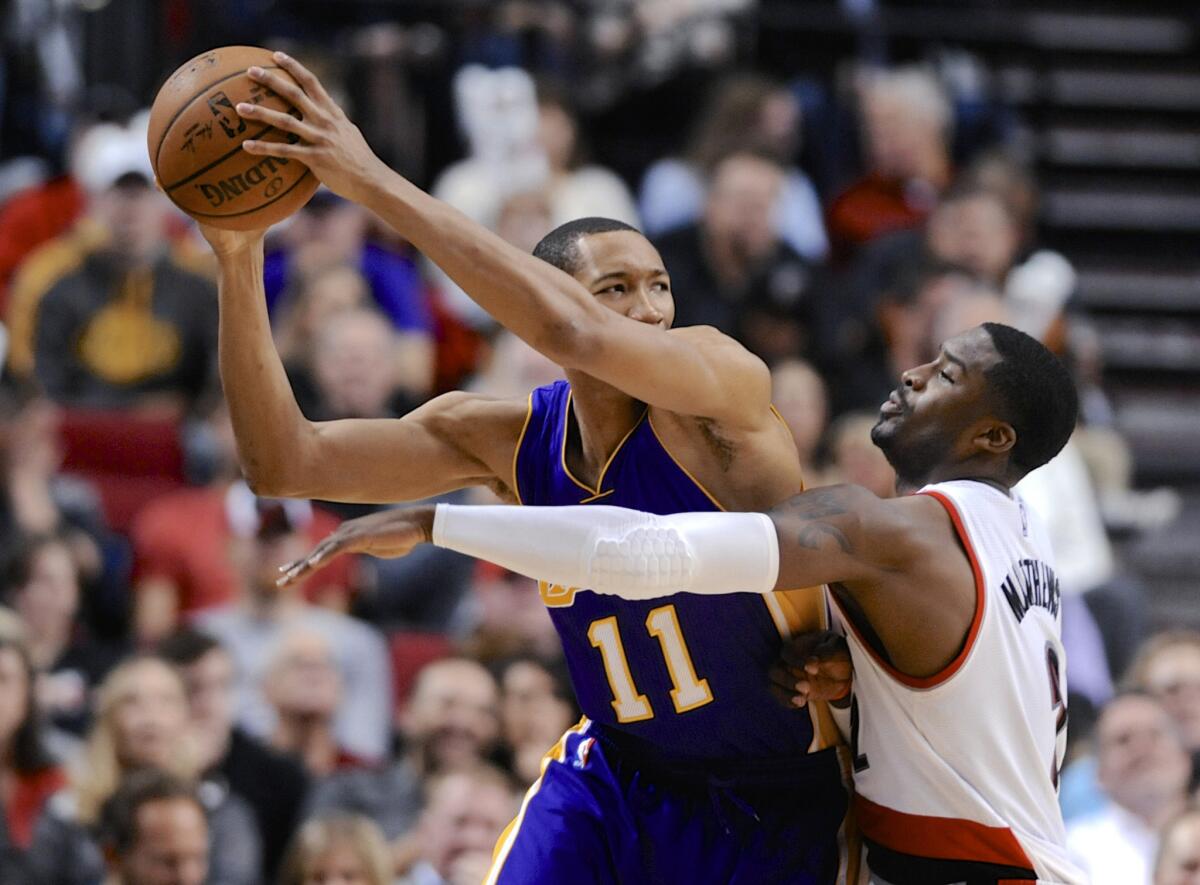 Wesley Johnson is defended by Portland guard Wesley Matthews during the second half of the Lakers' loss Wednesday to the Trail Blazers, 102-86.