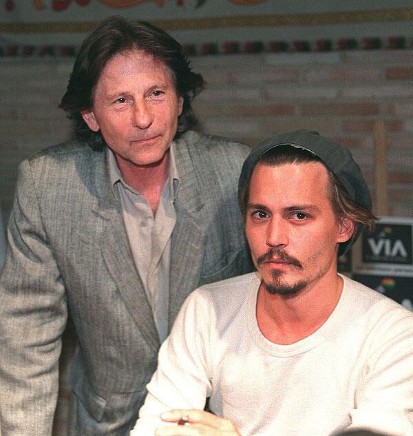 Film director, Roman Polanski stands behind actor Johnny Depp during a press conference in Toledo.