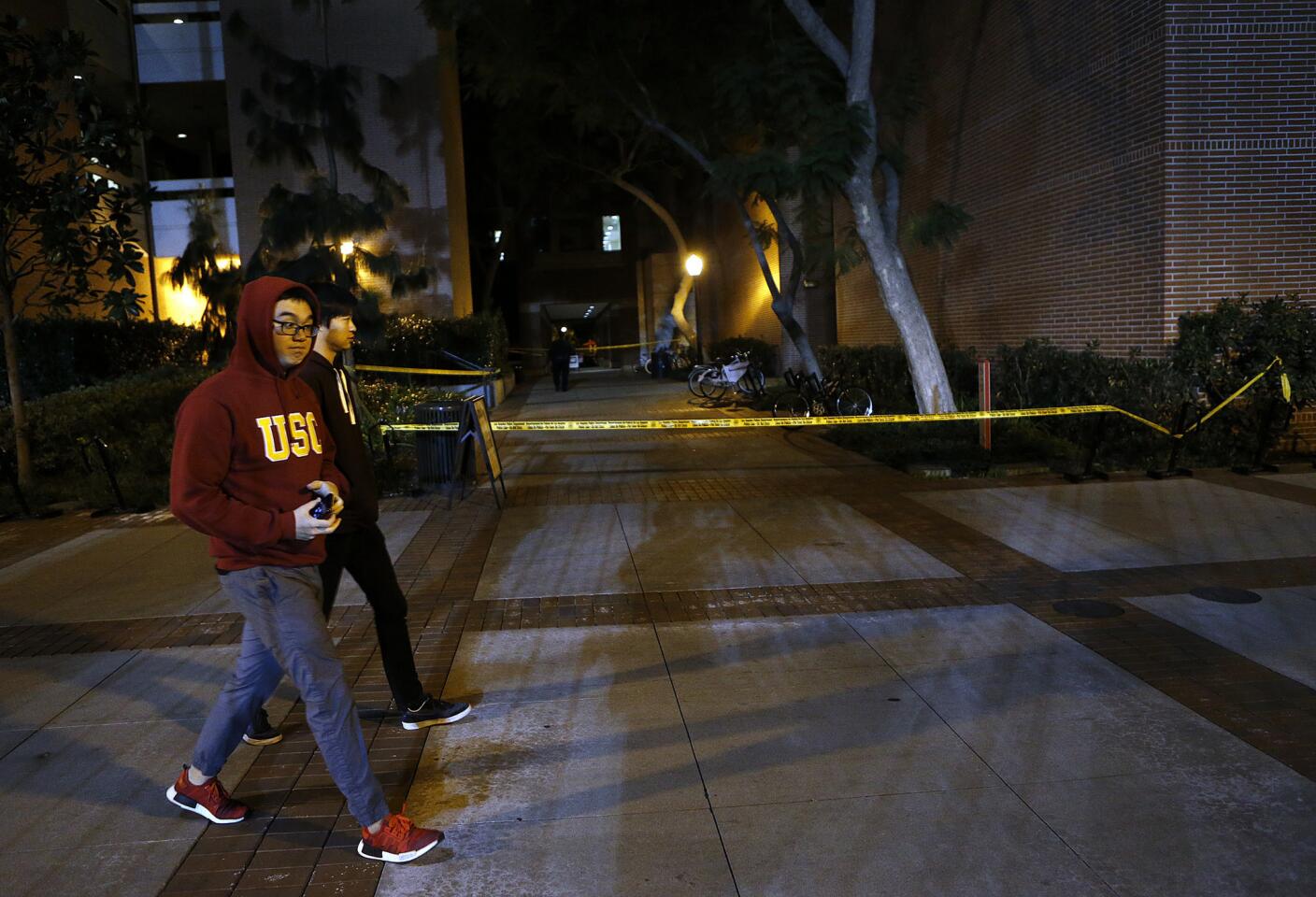 Yellow crime scene tape is seen near the entrance to the Seeley G. Mudd building on the USC campus.