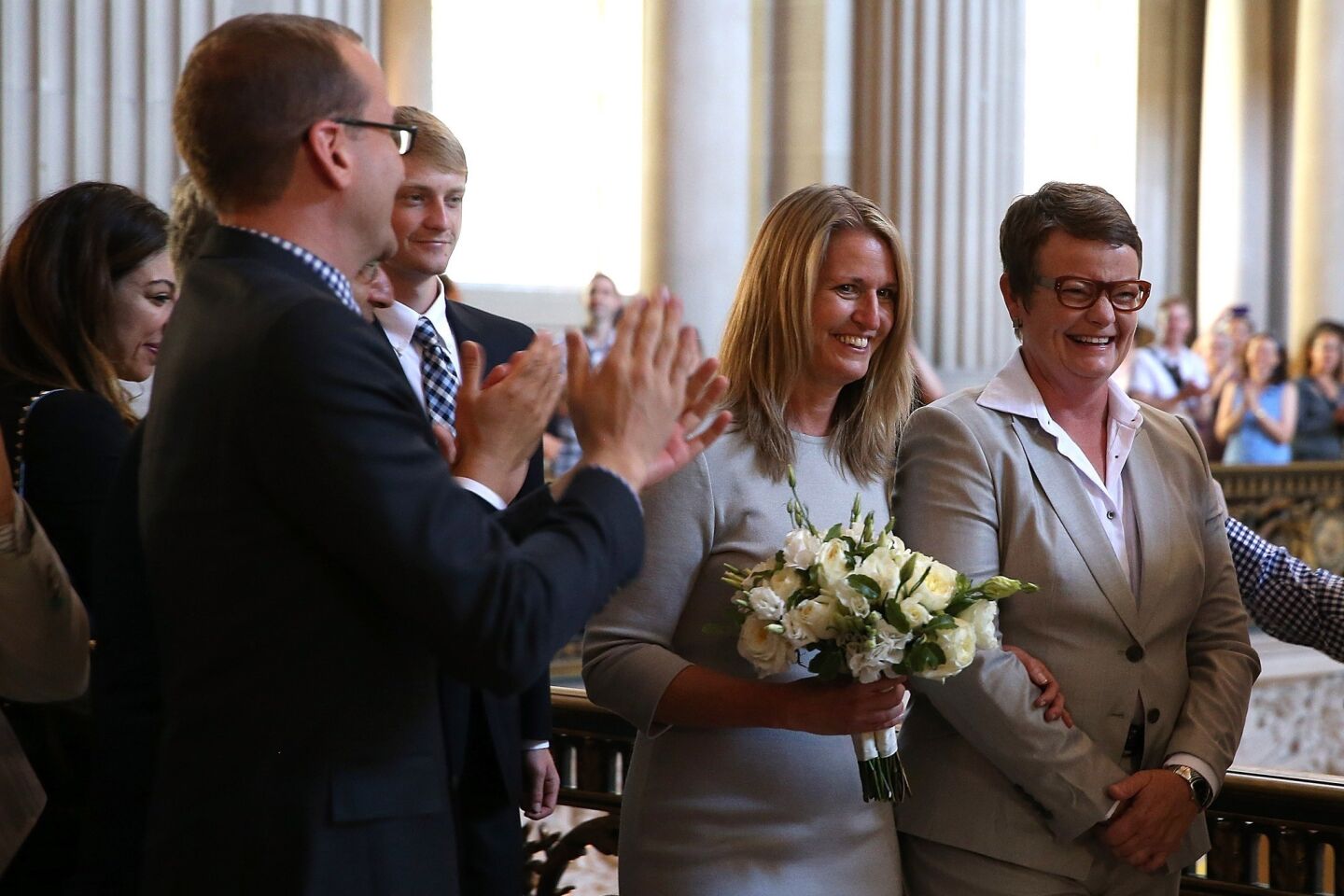 Supporters applaud as Sandy Stier, second from right, and Kris Perry prepare to get married at San Francisco City Hall by California Atty. Gen. Kamala Harris. Gov. Jerry Brown ordered all counties in the state to begin issuing licenses immediately after the 9th Circuit Court ruling.
