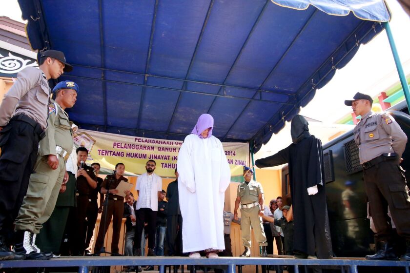 A 60-year-old Christian woman was caned in Aceh, a conservative Indonesian province, for selling alcohol. It was the first time someone from outside the Islamic faith has been punished there under strict religious laws.
