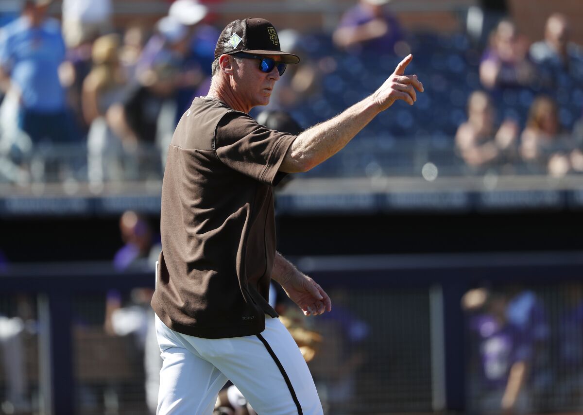 Padres manager Bob Melvin makes a pitching change during a spring training game against the Rockies 