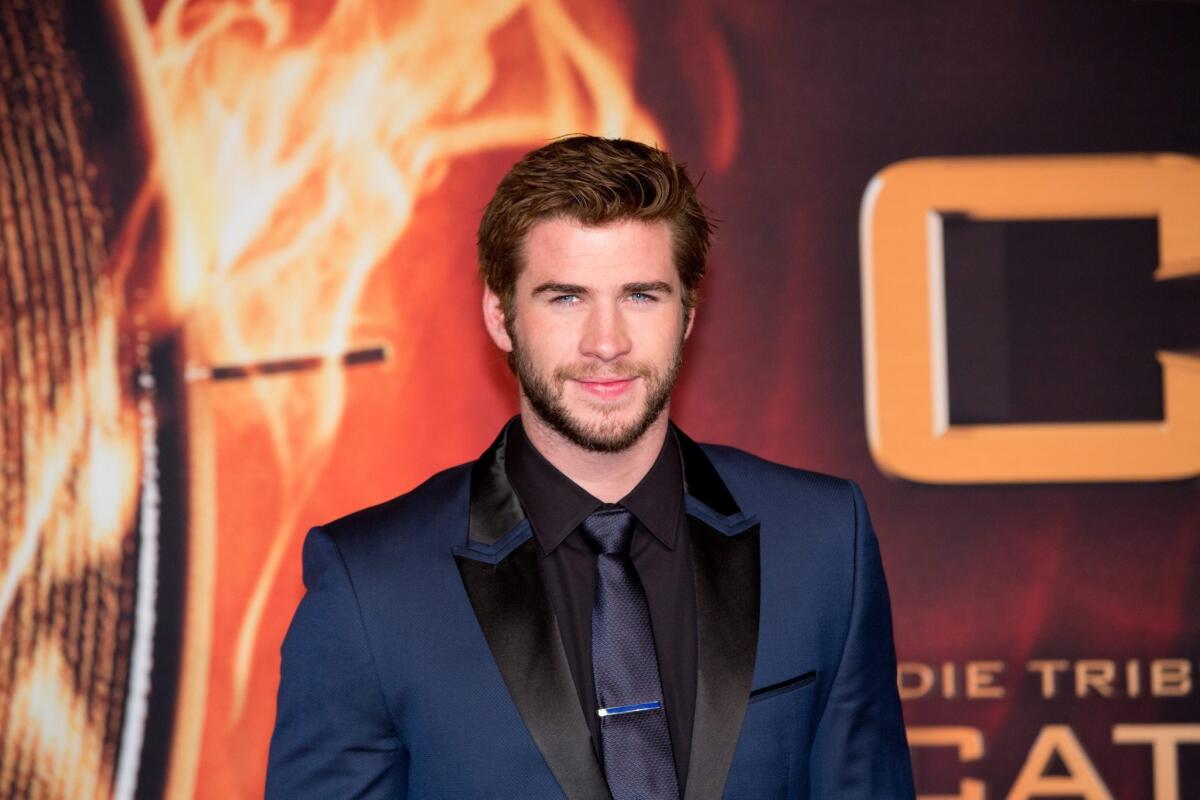 Liam Hemsworth of "The Hunger Games: Catching Fire" says he's happy for all of ex-fiancee Miley Cyrus' success.