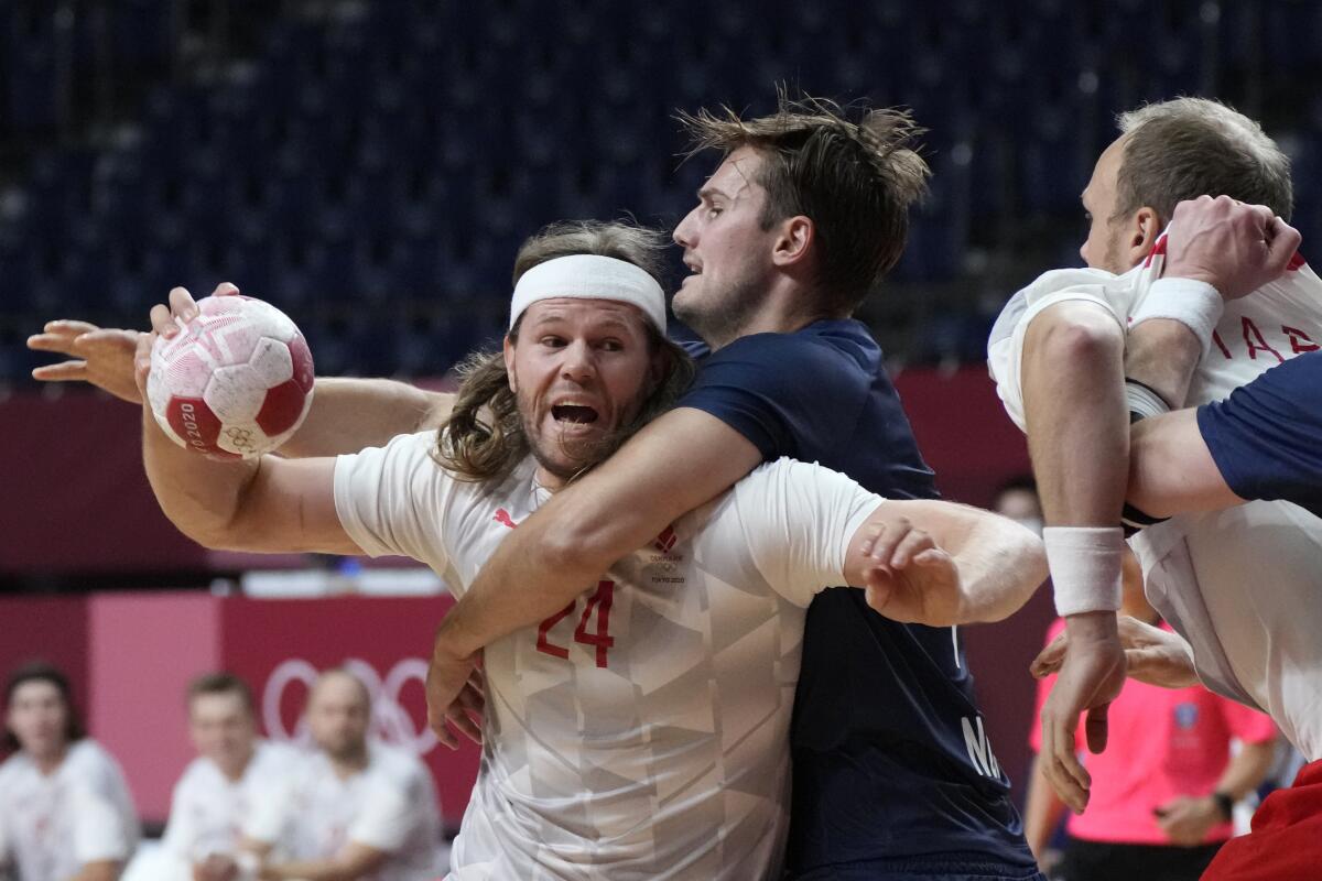 Denmark's Mikkel Hansen tries to score in a handball game at the Tokyo Olympics.