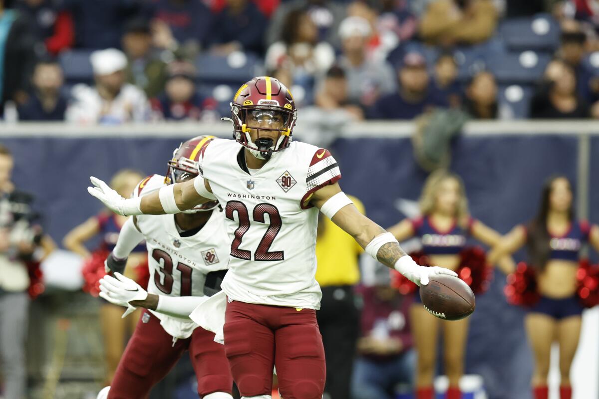 Washington Commanders defensive back Darrick Forrest celebrates after an interception.