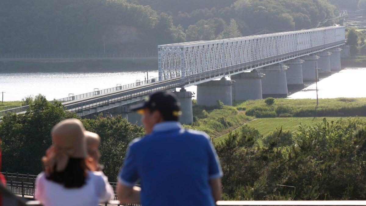 South Koreans visit Imjingak park near the Demilitarized Zone in Paju, South Korea, with views across the river of North Korea.