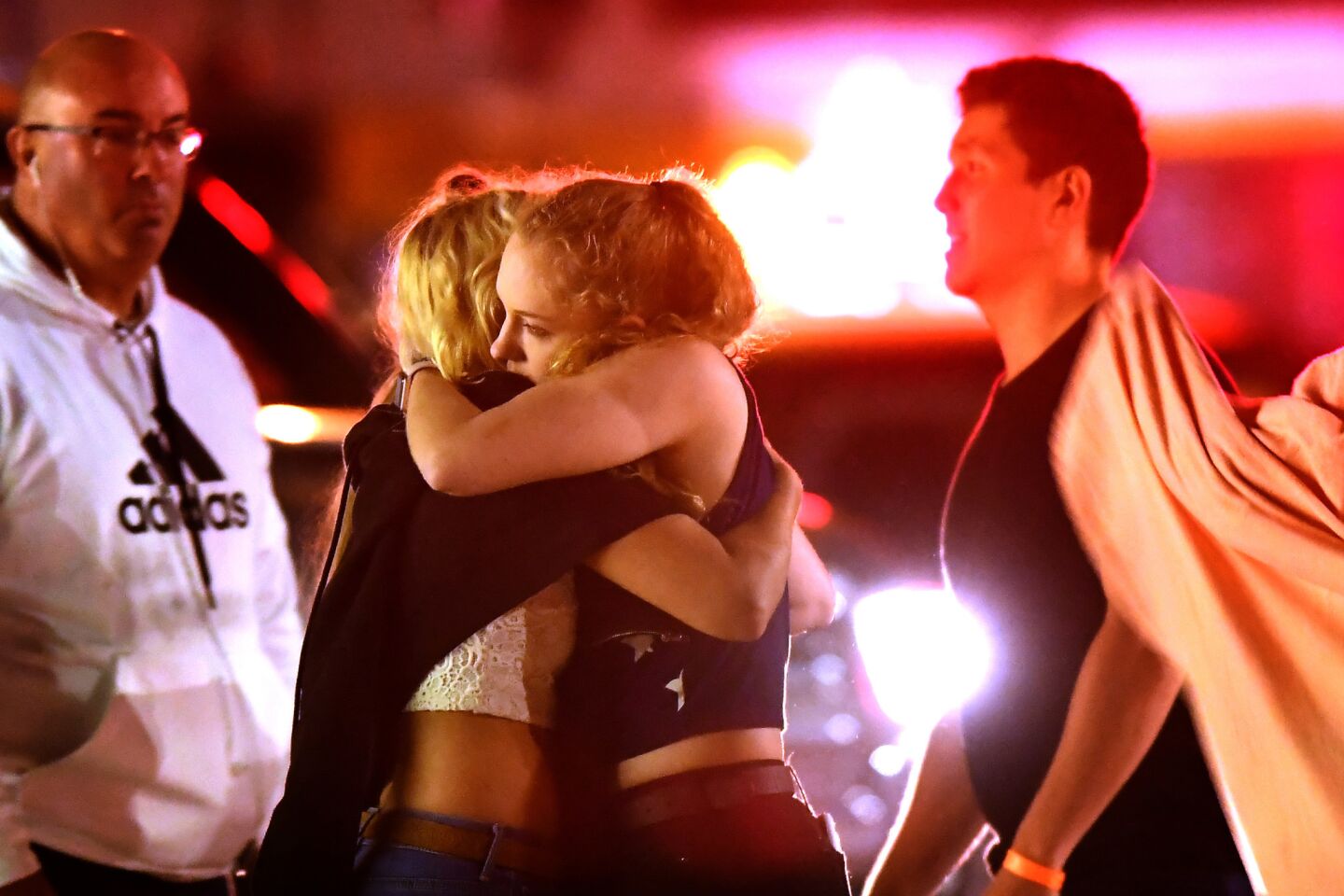 People comfort each other after a mass shooting at the Borderline Bar & Grill in Thousand Oaks on Nov. 7, 2018.
