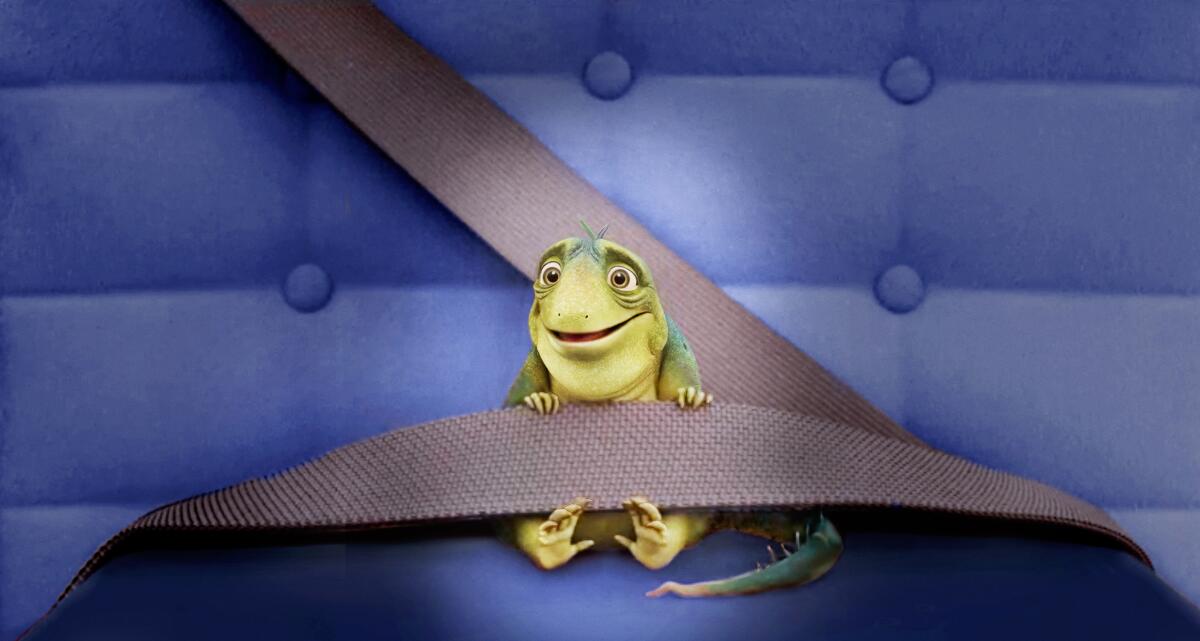 An image of a green cartoon lizard wearing a seat belt and seated on blue upholstery.