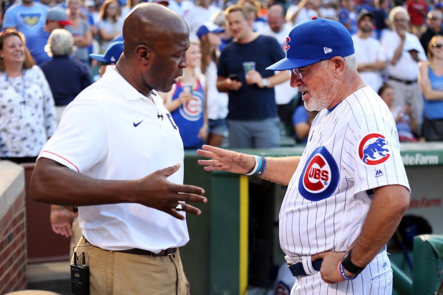 Illini football coach Lovie Smith shakes hands with Cubs manager Joe Maddon before a game at Wrigley on July 23, 2017.