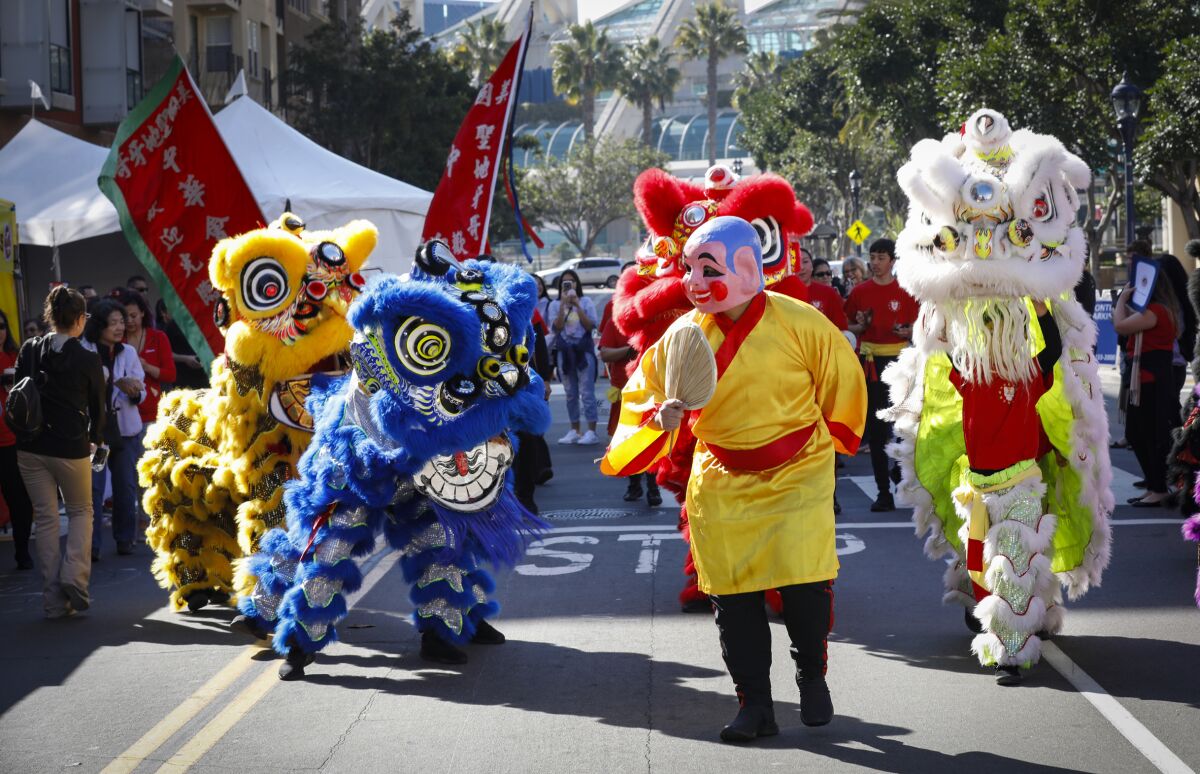 San Diego's Lucky Lion Dancers make their way thru the Gaslamp Quarter as the 38th Annual Chinese New Year Celebration.