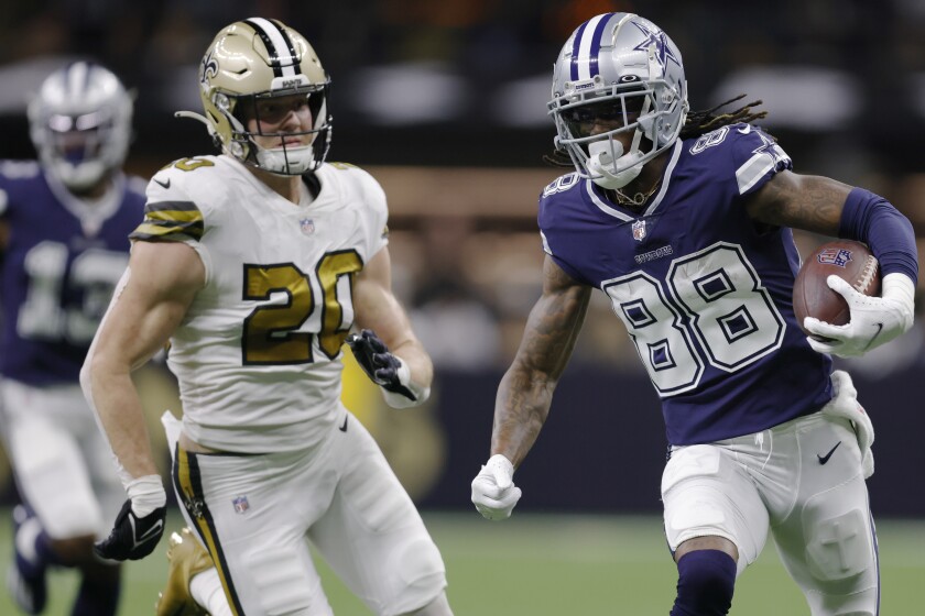 Dallas Cowboys wide receiver CeeDee Lamb (88) runs past New Orleans Saints linebacker Pete Werner (20) during the first half of an NFL football game, Thursday, Dec. 2, 2021, in New Orleans. (AP Photo/Brett Duke)