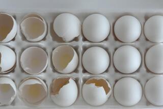 Used and unused eggs sit in a carton of 18 in a Chicago area home Tuesday, Jan. 10, 2023. Anyone going to buy eggs these days will have to be ready to pay up because the lingering bird flu outbreak, combined with soaring feed, fuel and labor costs, has driven prices up significantly. (AP Photo/Charles Rex Arbogast)