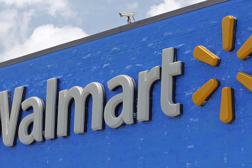 FILE - This Thursday, June 1, 2017, file photo, shows a Walmart sign at a store in Hialeah Gardens, Fla. Walmart is buying delivery company Parcel to help get groceries, other goods to customers in New York City faster. (AP Photo/Alan Diaz, File)