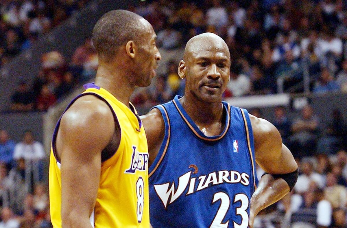 Kobe Bryant, left, and Michael Jordan talk during a break in action between the Lakers and Washington Wizards